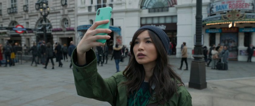 Sersi holding her phone up in Piccadilly Circus.