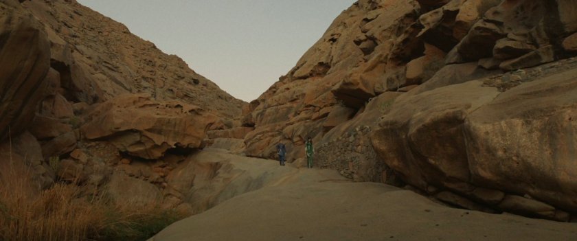 Sersi and Ikaris in rocky canyon in ancient Babylon..