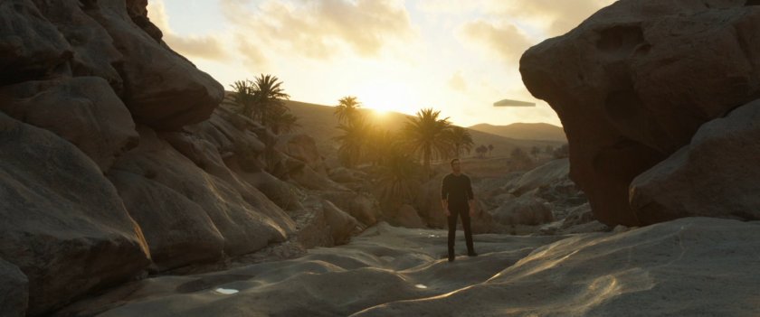 Ikaris stands in a rocky valley in Iraq.