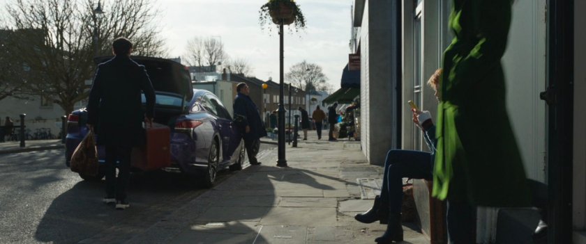 Car parked in front of row home in London.