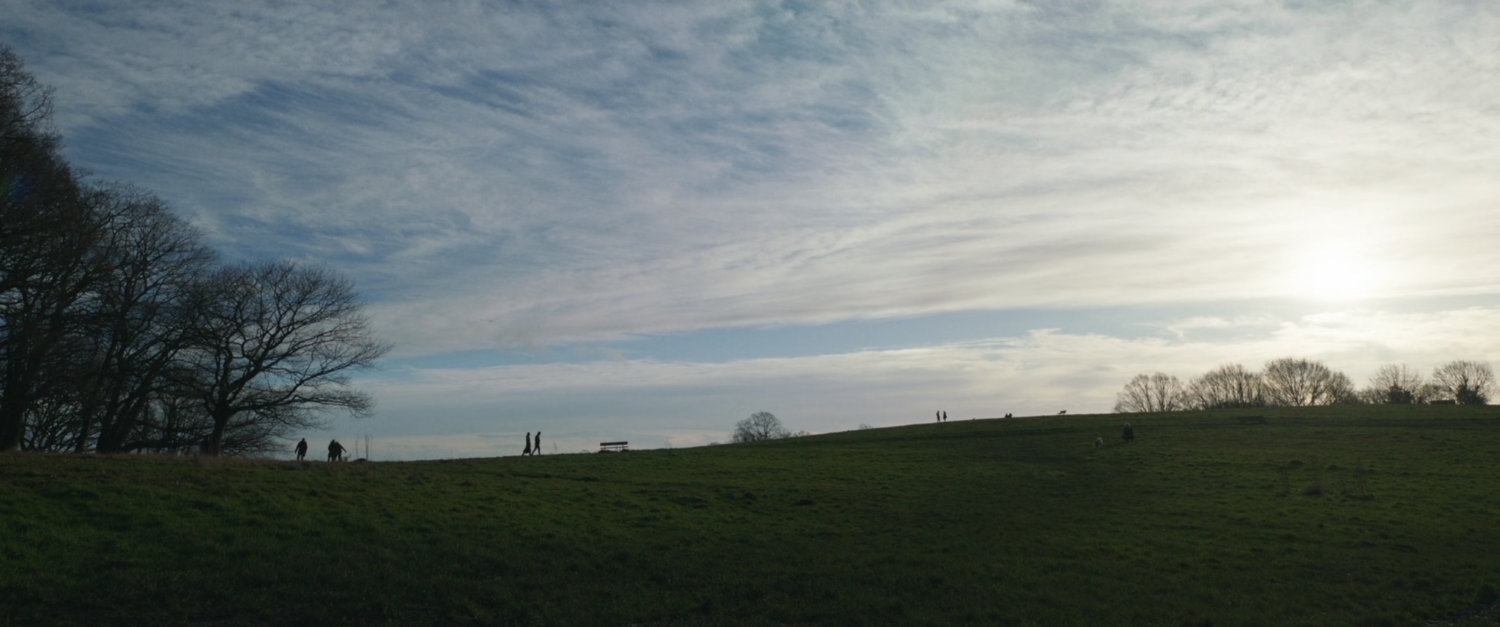 Wide view of hilly London park.