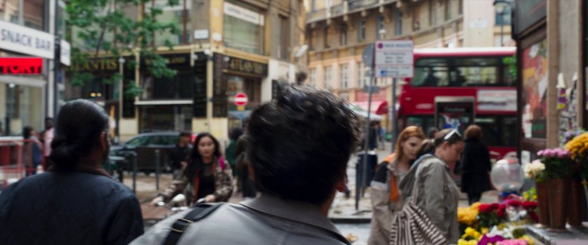 Steven walks through a crowded London street towards a bus.