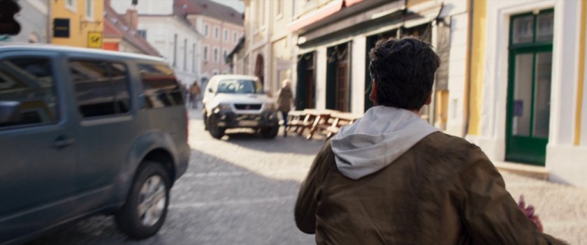 Steven runs through a German village.