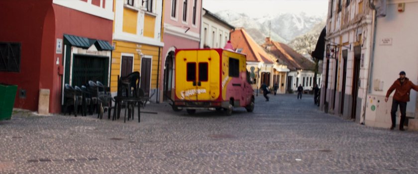 A cupcake truck drives out of a German village.