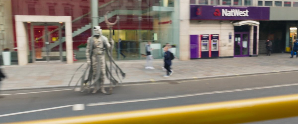 Khonshu standing on a London sidewalk.