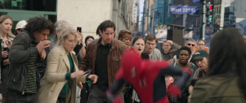 Spider-Man and MJ are harassed by crowds at the entrance to the Penn Station subway.