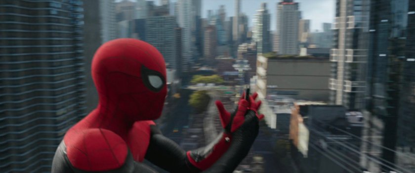 Spider-Man looking at his phone from high over New York City.