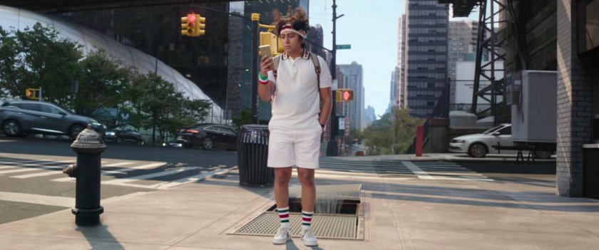 Flash Thompson standing on a New York street corner.
