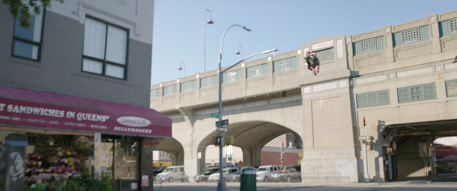 Exterior of Delmar's III on a Queens street corner with Spider-Man swing into background.