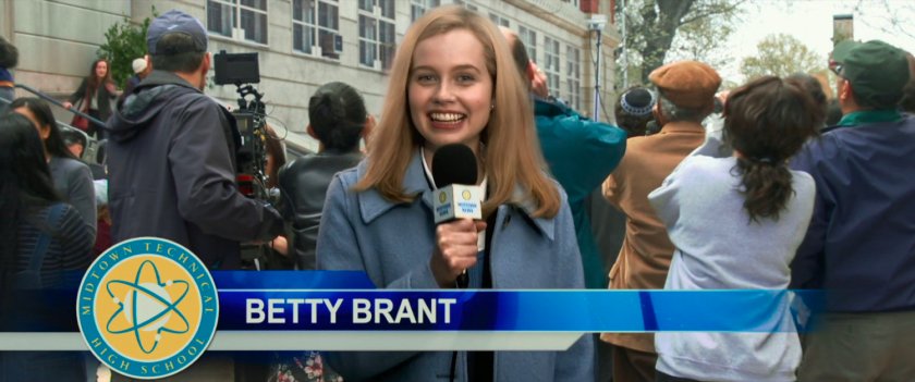 Student reporter Betty Brant reporting from in front of Midtown High.