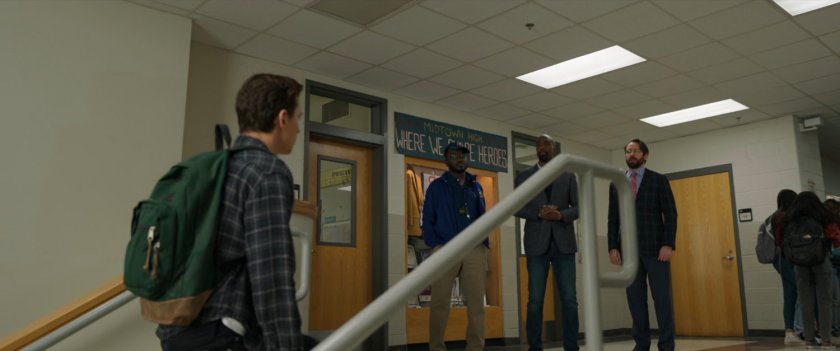 Peter Parker walking up stairs towards teachers inside  Midtown High.