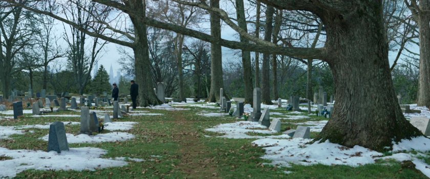 Peter Parker and Happy Hogan in a snowy graveyard.