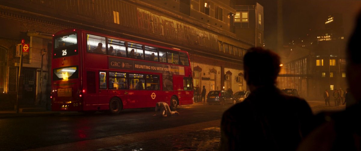 Mr Knight fighting a Jackal creature by a London bus.