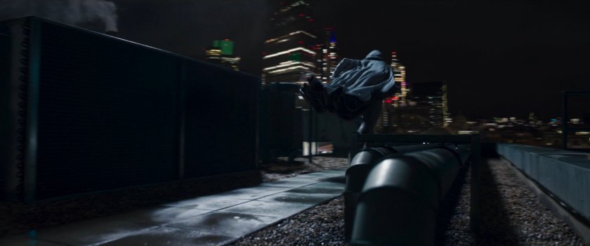 Moon Knight running across a dark London rooftop.