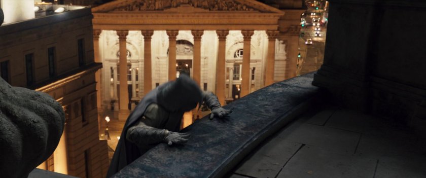 Moon Knight climbing onto a dark London rooftop.
