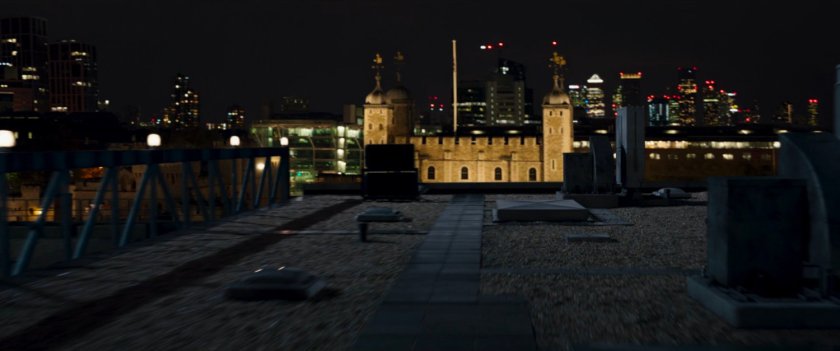 Moon Knight running across a dark London rooftop towards the Tower of London.
