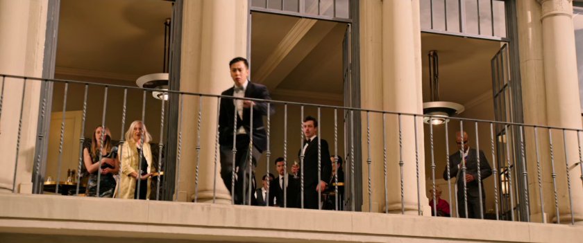 Crowd looking down from a balcony.