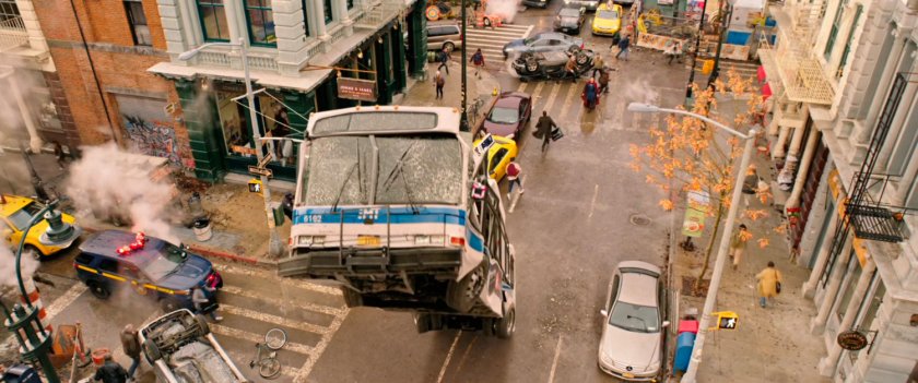 a city bus flipping in an intersection in New York street.