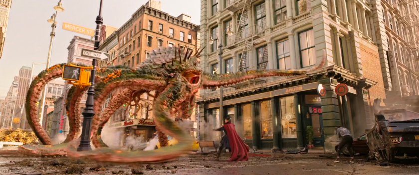 Dr Strange fighting a tentacled beast in an intersection in New York city.