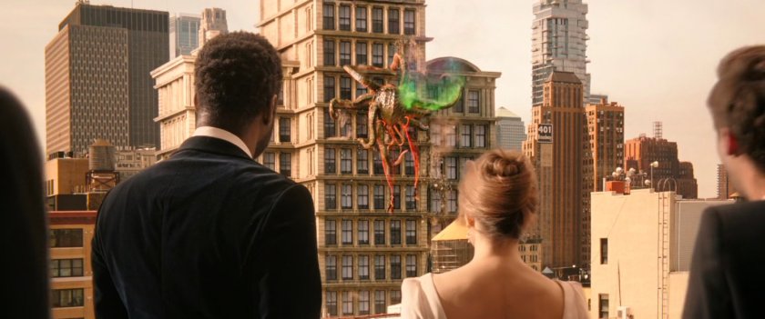 A tentacled beast climbs up a New York skyscraper as watched by wedding guests.