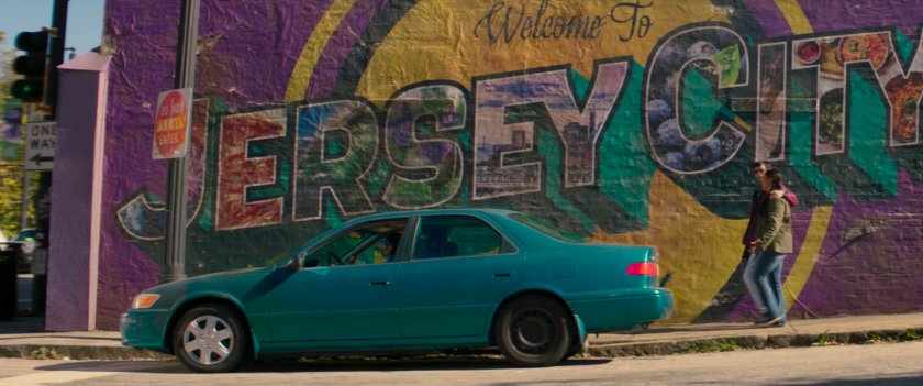 Car in front of Welcome to Jersey CIty mural.