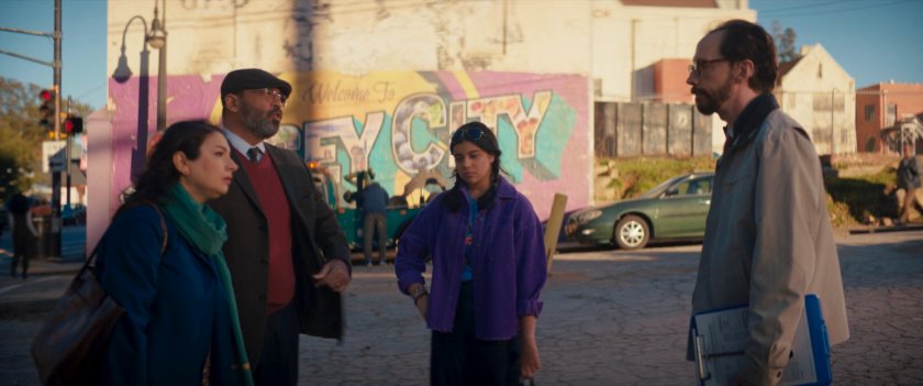 Muneeba, Yusuf and Kamala with a driving instructor in front of Welcome to Jersey City mural.