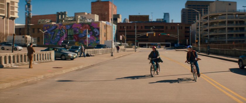Kamala and Bruno riding their bikes on a street.