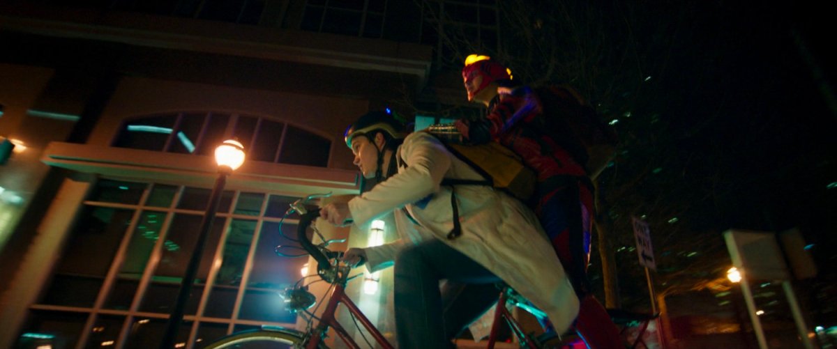 Kamala and Bruno on a bike at night.