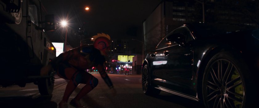 Kamala lands in a street next to a car.