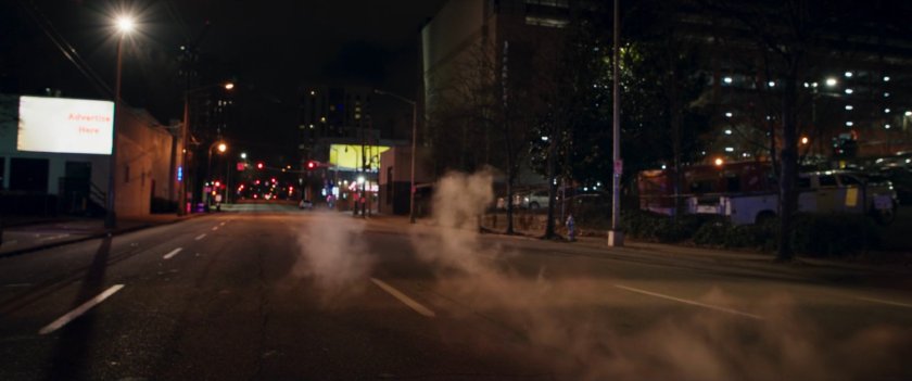A car speeds away from a Jersey City alley.