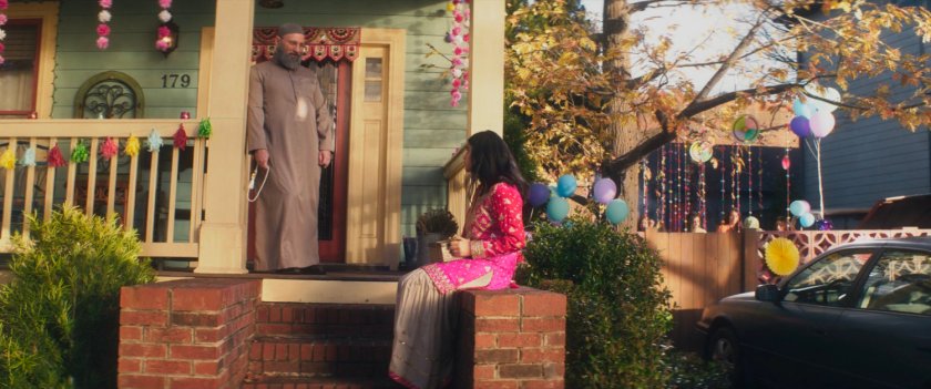 Kamala and the Iman on the front porch of the Khan house.