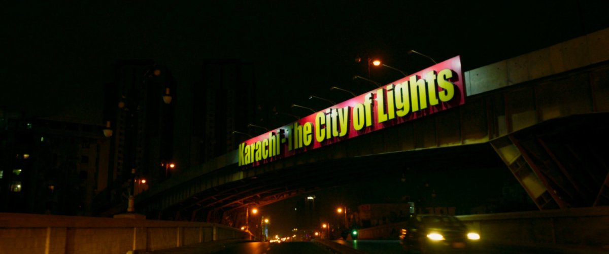 Karachi bridge with "City of Lights" sign on it.