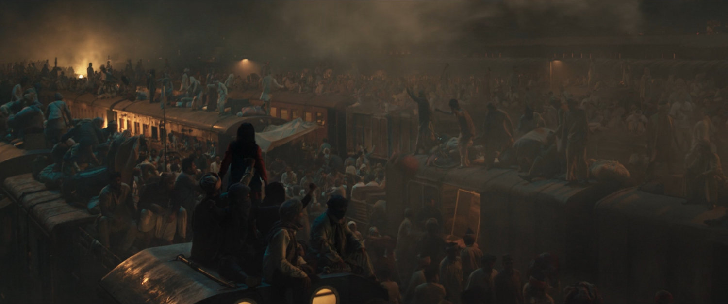 People crowd on and around trains at Indian Railways Train Station.