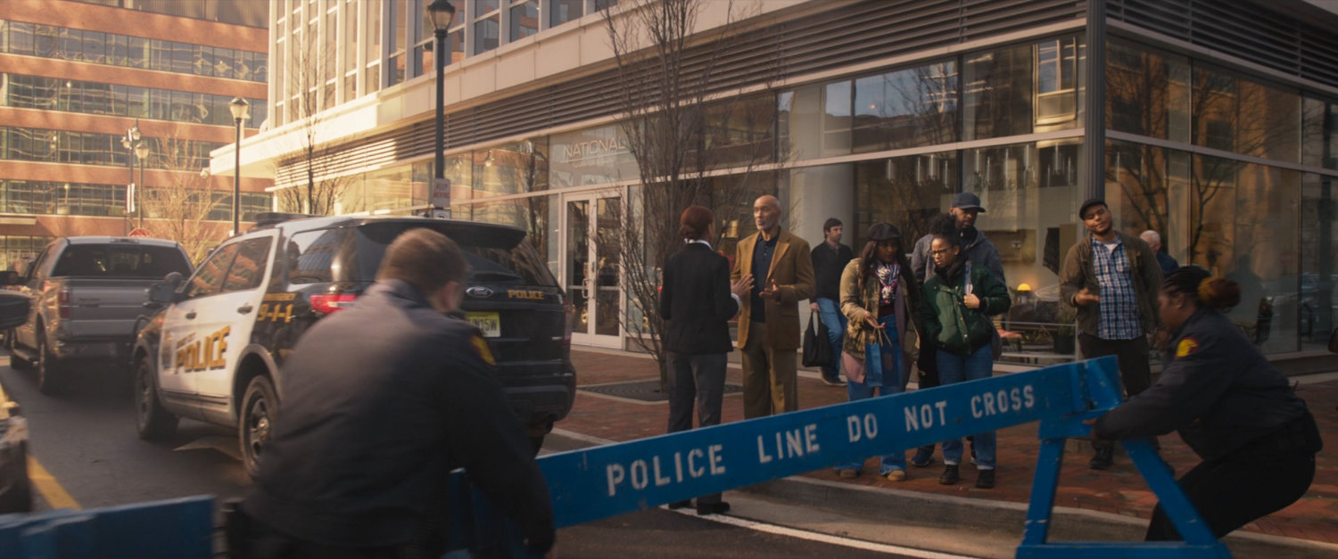 Police set up a cordon to keep pedestrians on sidewalk.