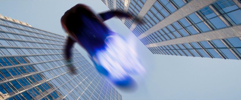 Ms Marvel runs past on platforms of hard light.