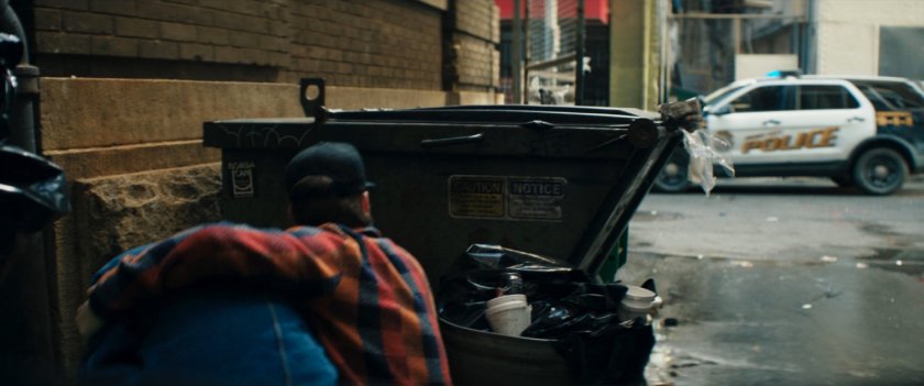 Bruno and Kamran hide in an alley from a police car.