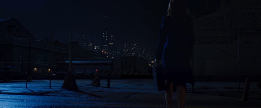 Nighttime shot of Peggy Carter walking towards warehouse.