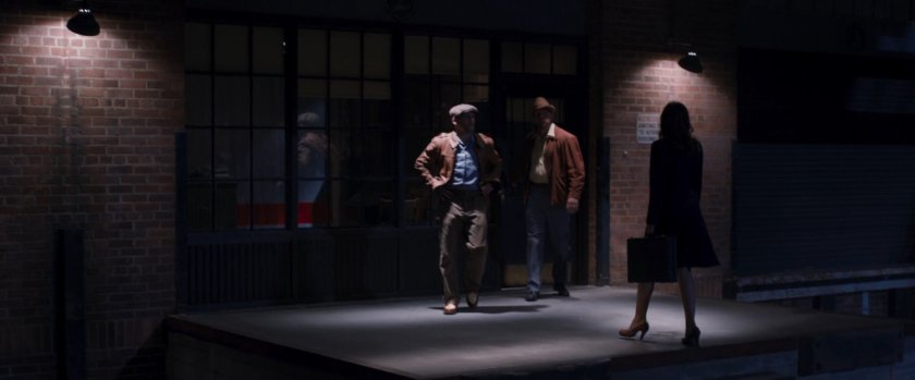 Peggy Carter and two men outside warehouse.