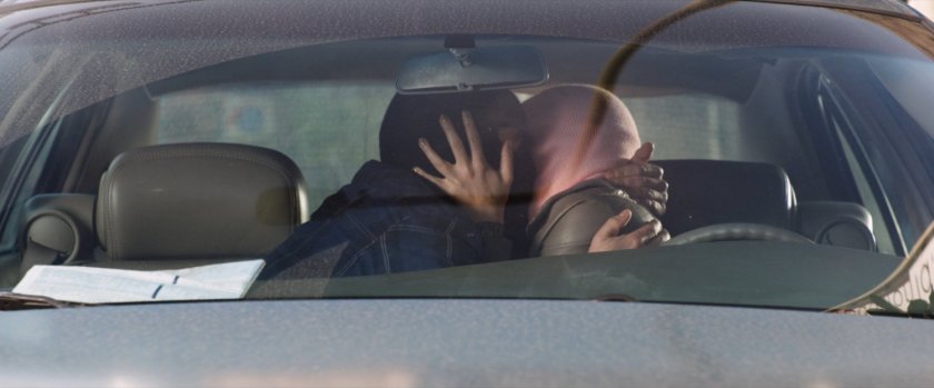 Claire and Benny kissing in car.
