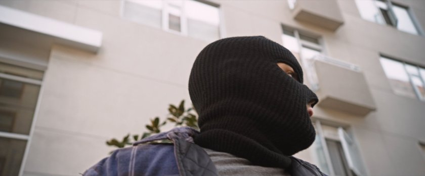 Benny with black ski mask exiting car.