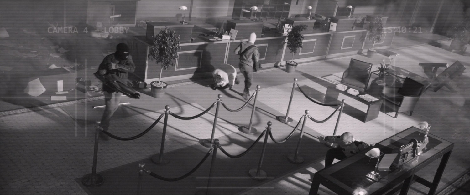 Black and white security footage of bank robbery.