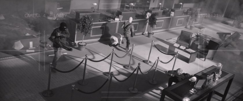 Black and white security footage of bank robbery.