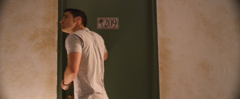 Benny knocking on motel door number 209.