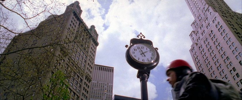 Peter Parker looks at clock in park.