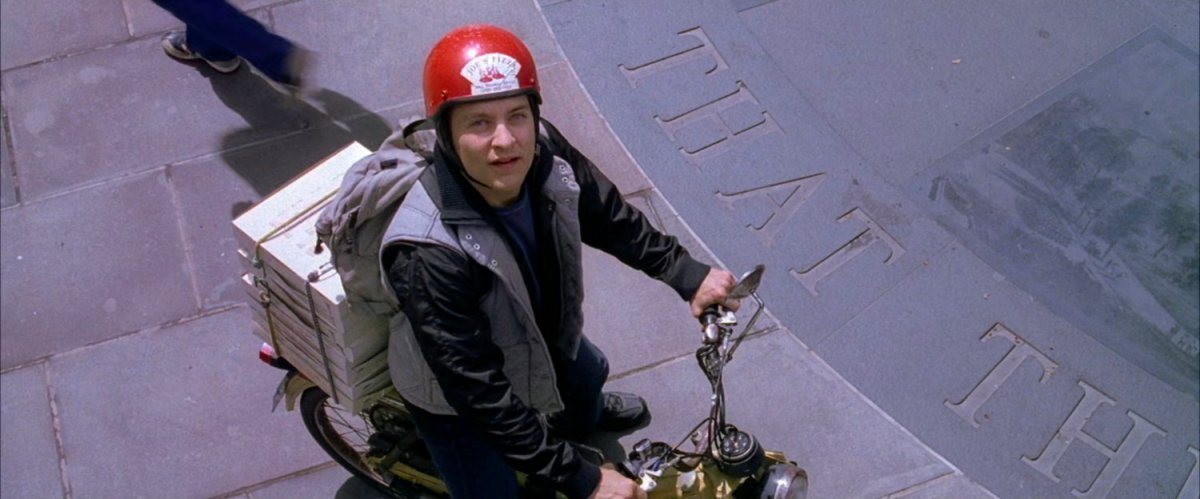 Peter Parker looks at clock in park.