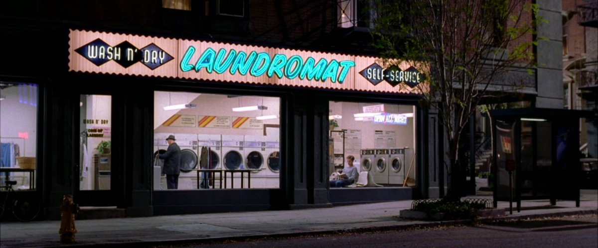 Exterior laundromat at night.