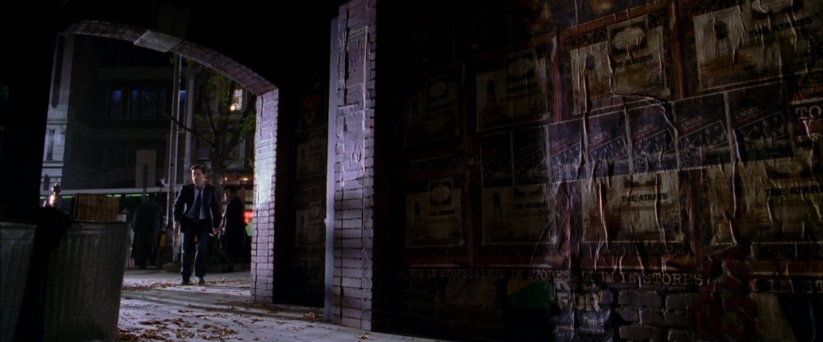 Peter Parker entering alley at night.