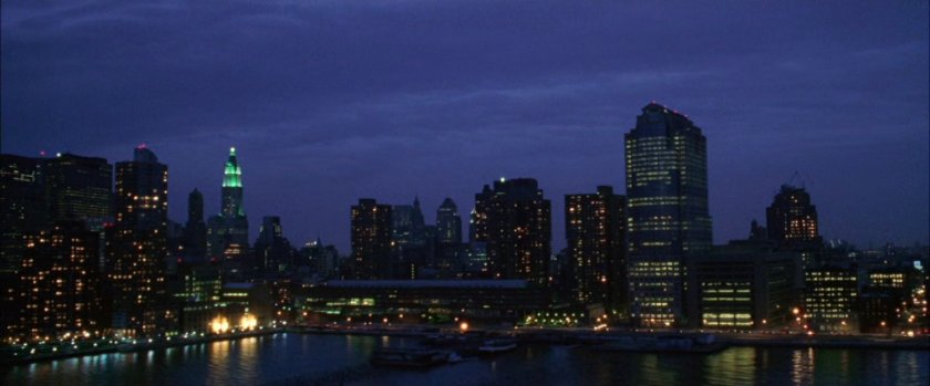 Night exterior of New York harbor and city.