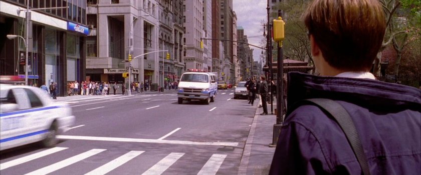 Peter Parker watching police cars drive by.