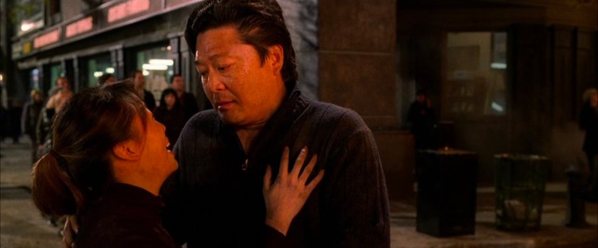 Couple outside apartment on fire.